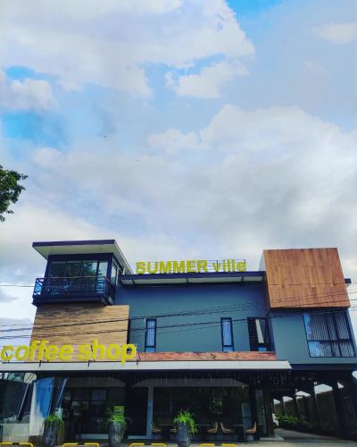 a coffee shop with a sign on a building at Hotel Summerville in Majalengka