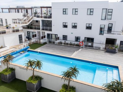 an apartment with a large swimming pool in front of a building at Azure 213 - Luxury 2 Bedroom Apartment in Big Bay