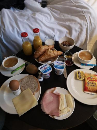a table full of breakfast foods on a bed at Zakske13 - Design Boutique B&B in Bruges city centre in Bruges