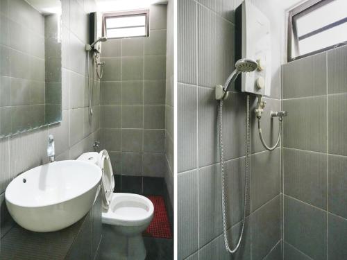 a bathroom with a shower and a sink and a toilet at OYO 89950 365 Nice Stay in Miri