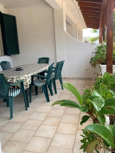 a patio with a table and chairs and plants at Casa Anter Santa Maria di Leuca in Leuca