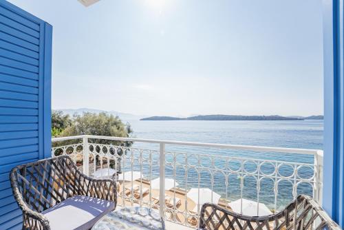 a balcony with chairs and a view of the water at Greek Beach House A6 Lefkada in Nydri