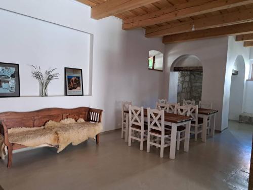 a living room with a bed and a table and chairs at Tarcal Apartman in Tarcal