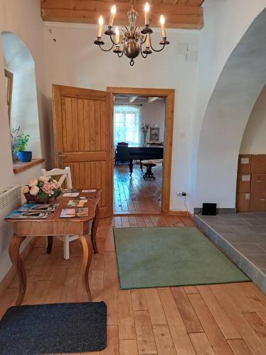 a living room with a table and a piano at Tarcal Apartman in Tarcal