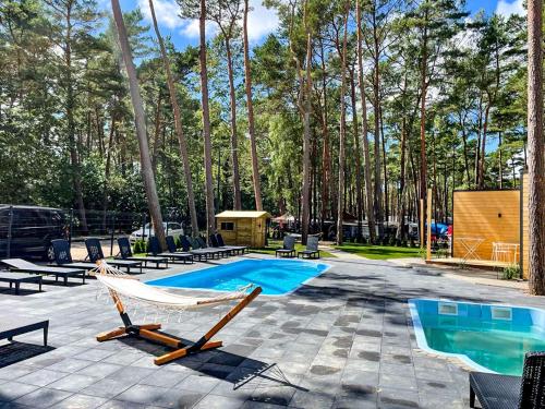 a patio with chairs and a swimming pool at Seaside Harmony in Pogorzelica