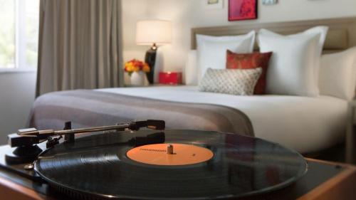 a record player in a hotel room with a bed at Uma House by Yurbban South Beach in Miami Beach