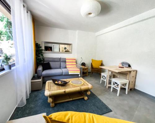 a living room with a couch and a table at KORALA T2 Marne ville & plage in Biarritz