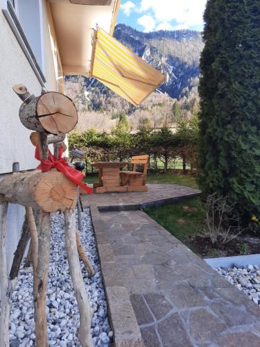a statue of a chicken and an umbrella on a patio at Apartma Rožle in Mojstrana