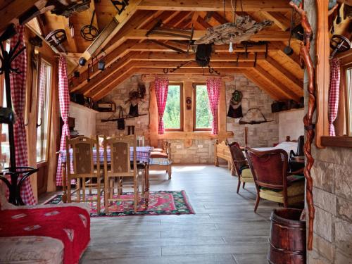 a dining room with a table and chairs at Ethno Village Štitarica in Mojkovac