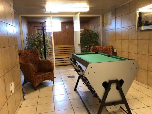 a pool table in a room with chairs at Big house, sauna, Wi-Fi, Isaberg, MTB, skiing, golf in Gnosjö