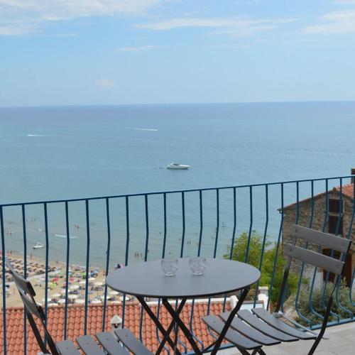 una mesa y sillas en un balcón con vistas al océano en Cristalli di mare room, en Sperlonga