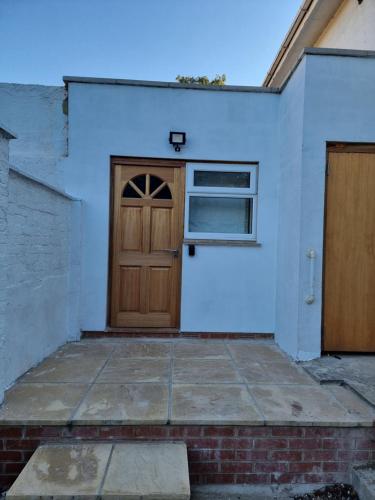 a wooden door on a white wall with a window at Studio room in Oxford