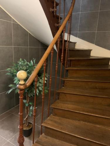 a staircase in a house with a wooden railing at Studio Renard, style bohème et atypique, Curistes in Luxeuil-les-Bains