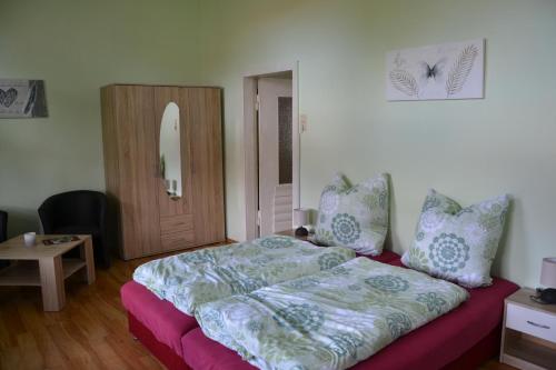 a bedroom with a bed and a wooden door at Villa Brockenstürmer in Wernigerode