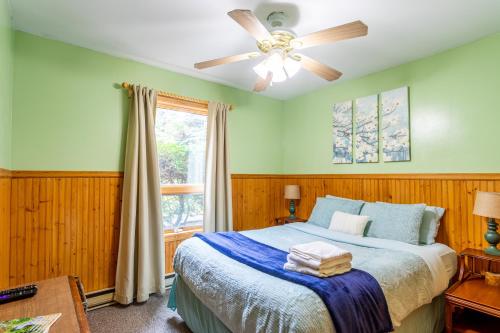 a bedroom with a bed and a ceiling fan at Mountainside Haven - walk to Hunter Mtn! in Hunter
