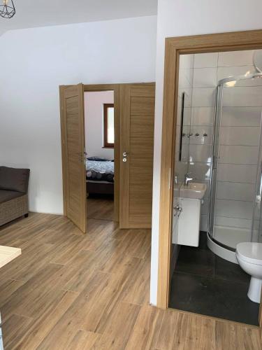 a bathroom with a shower and a toilet and a sink at Choczewski Zakątek in Choczewo