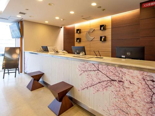 an office with a reception counter with a flower mural at Comfort Hotel Akita in Akita