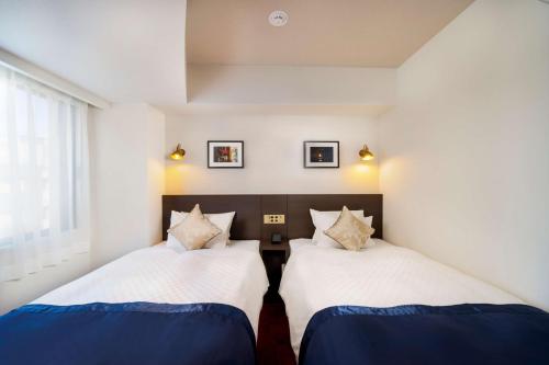 Postel nebo postele na pokoji v ubytování Best Western Hotel Fino Shin-Yokohama