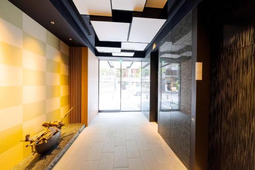 a hallway with a ceiling with a glass door at Best Western Hotel Fino Tokyo Akasaka in Tokyo