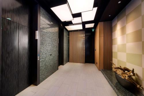 a hallway of a building with wooden walls and a ceiling with lights at Best Western Hotel Fino Tokyo Akasaka in Tokyo