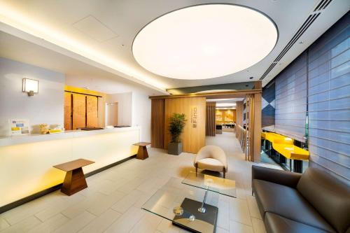 a lobby of a hospital with a couch and a table at Best Western Hotel Fino Tokyo Akasaka in Tokyo