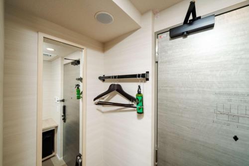 a shower in a bathroom with a glass shower door at Best Western Hotel Fino Tokyo Akasaka in Tokyo