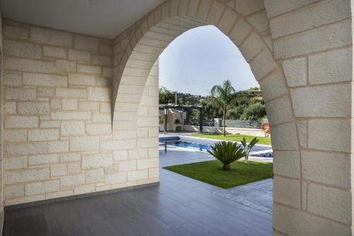an archway in a house with a swimming pool at Villa-Azalea in Almirida