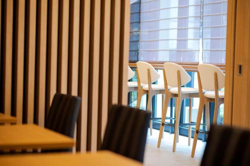 a room with chairs and a table and a window at Best Western Hotel Fino Tokyo Akasaka in Tokyo