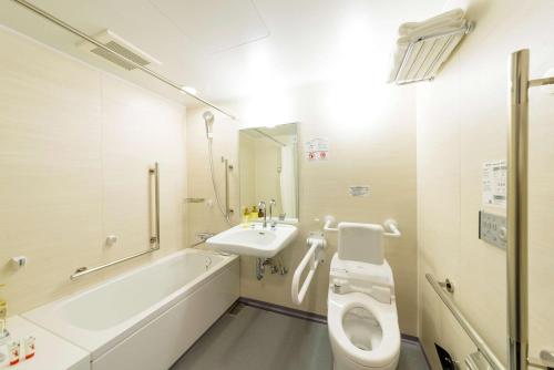 a bathroom with a sink and a toilet and a bath tub at Best Western Plus Hotel Fino Osaka Kitahama in Osaka