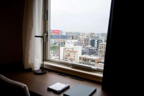 a window in a room with a view of a city at Best Western Plus Fukuoka Tenjin-minami in Fukuoka