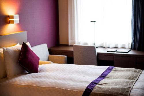 a hotel room with a bed and a desk at Best Western Plus Fukuoka Tenjin-minami in Fukuoka