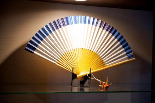 a fan on a glass shelf with a toy on it at Best Western Plus Fukuoka Tenjin-minami in Fukuoka