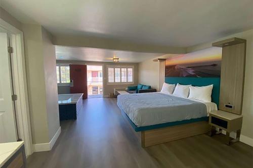 a bedroom with a large bed and a bathroom at Super 8 by Wyndham Oceanside Downtown in Oceanside