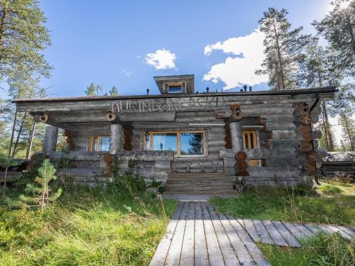 a log cabin in the woods with a sign on it at Holiday Home Kuukkelin kumpu by Interhome in Ruka