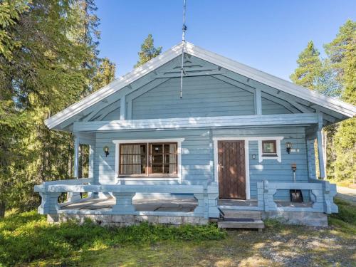 a blue tiny house with a porch at Holiday Home Uolevintie 39a by Interhome in Ruka