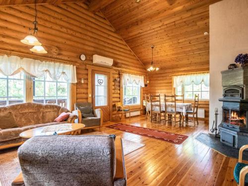 a living room with a couch and a fireplace at Holiday Home Sarvitupa by Interhome in Kangashäkki