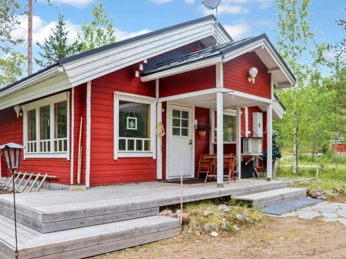 a red tiny house with a porch at Holiday Home Hyryn herra cottage by Interhome in Hyrynsalmi