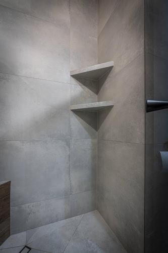 a shower with three shelves in a shower stall at Good Morning Giewont & JACUZZI in Kościelisko