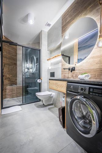 a bathroom with a washing machine and a shower at Good Morning Giewont & JACUZZI in Kościelisko