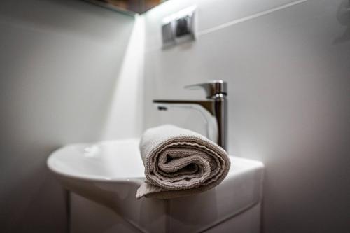 a towel on the side of a sink in a bathroom at Good Morning Giewont & JACUZZI in Kościelisko
