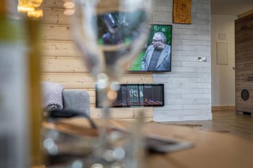 a living room with a brick wall with a tv at Good Morning Giewont & JACUZZI in Kościelisko