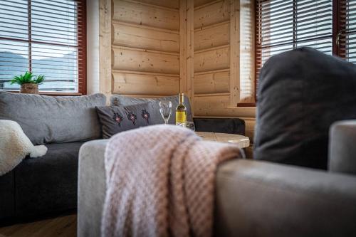 a living room with a couch and a table at Good Morning Giewont & JACUZZI in Kościelisko