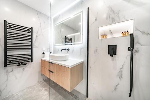 a white bathroom with a sink and a mirror at Baie de Monaco, Vue Mer, Terrasse, Parking Gratuit - AF in Beausoleil