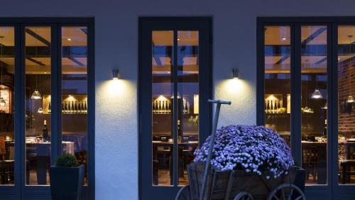 a blue building with a bunch of purple flowers at WeinHotel Fritz Walter in Niederhorbach