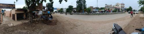 an empty street in a city with a fence at HOTEL ROYAL INN in Satna