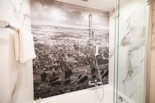 a bathroom with a mural of a city at Hotel Royal in Vienna