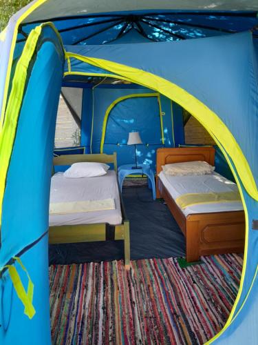 two beds in a blue and yellow tent at Villa Menta in Lefkada