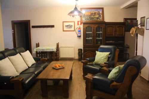 a living room with a couch and chairs and a table at Atxispe Etxea Casa Rural in Laukiz