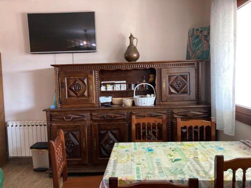 a large wooden entertainment center with a television on a wall at Atxispe Etxea Casa Rural in Laukiz