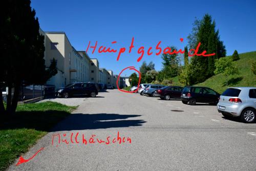 a street with cars parked in a parking lot at Rosenalm - Appartement 30 in Scheidegg